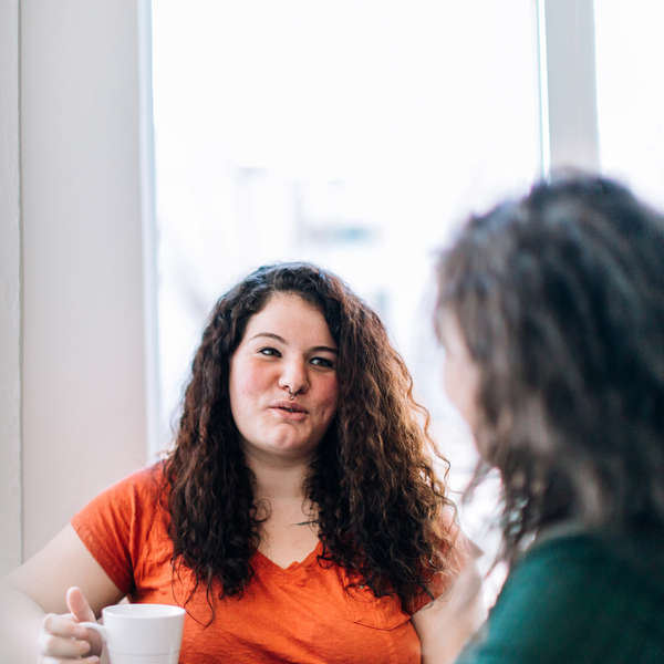 Two women are talking together